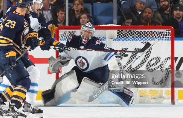 Steve Mason of the Winnipeg Jets follows the puck on a deflection during the second period of an NHL game against the Buffalo Sabres on January 9,...