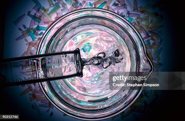 test tube pouring into beaker - liquid solution stock pictures, royalty-free photos & images