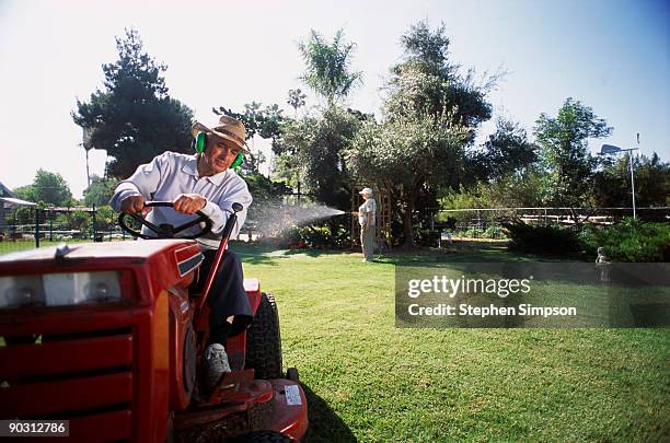 man mowing lawn - riding lawnmower stock pictures, royalty-free photos & images