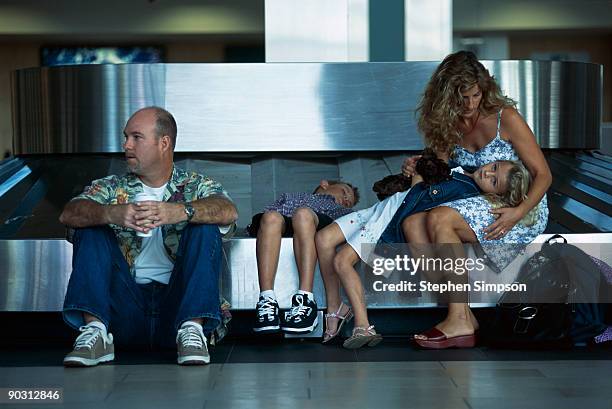 family waiting at baggage claim - airport frustration stock pictures, royalty-free photos & images