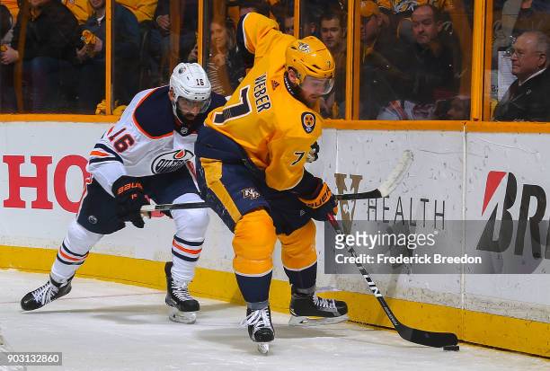 Yannick Weber of the Nashville Predators skates against Jujhar Khaira of the Edmonton Oilers during the second period at Bridgestone Arena on January...
