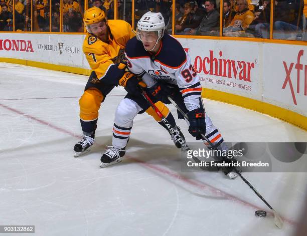 Yannick Weber of the Nashville Predators defends against Ryan Nugent-Hopkins of the Edmonton Oilers during the second period at Bridgestone Arena on...