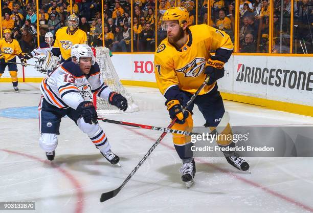 Michael Cammalleri of the Edmonton Oilers skates against Yannick Weber of the Nashville Predators during the second period at Bridgestone Arena on...