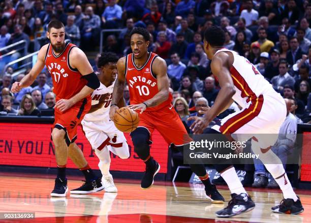 DeMar DeRozan of the Toronto Raptors dribbles the ball as Hassan Whiteside of the Miami Heat defends during the second half of an NBA game at Air...