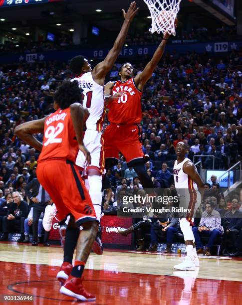 DeMar DeRozan of the Toronto Raptors shoots the ball as Hassan Whiteside of the Miami Heat defends during the second half of an NBA game at Air...