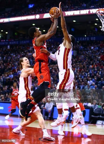 DeMar DeRozan of the Toronto Raptors shoots the ball as Wayne Ellington of the Miami Heat defends during the second half of an NBA game at Air Canada...