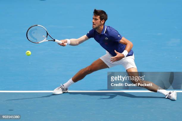 Novak Djokovic of Serbia plays a forehand against Dominic Thiem of Austria in the 2018 Kooyong Classic at Kooyong on January 10, 2018 in Melbourne,...