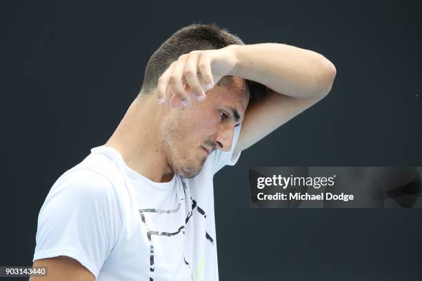 Bernard Tomic of Australia wipes away sweat during a practice session ahead of the 2018 Australian Open at Melbourne Park on January 10, 2018 in...