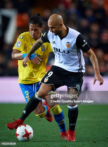 Andreas Pereira of Valencia competes for the ball with Mauricio Lemos of Las Palmas during the Copa Del Rey 2nd leg match between Valencia and Las...