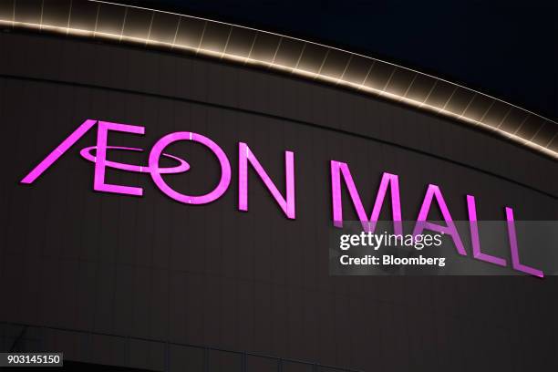 Signage is displayed atop an Aeon shopping mall, operated by Aeon Mall Co., a unit of Aeon Co., at night in Chiba, Chiba Prefecture, Japan, on...