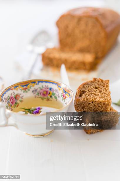 pain d'epices with a cup of jasmine tea - estaciones stockfoto's en -beelden