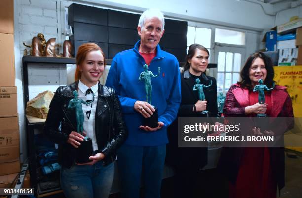 Elizabeth McGlaughlin , Daryl Anderson , Clea Duvall and Ann Dowd poses with the statue known as 'the Actor' at the American Fine Arts Foundry on...