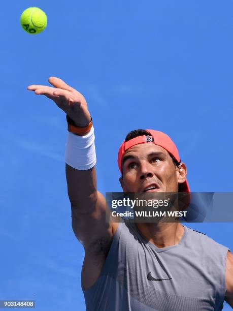 Rafael Nadal of Spain serves during a training session ahead of the Australian Open at Melbourne Park in Melbourne on January 10, 2018. / AFP PHOTO /...