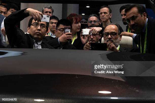 Attendees browse exhibition on autonomous driving at the Hyundai Mobis booth during CES 2018 at the Las Vegas Convention Center on January 10, 2018...