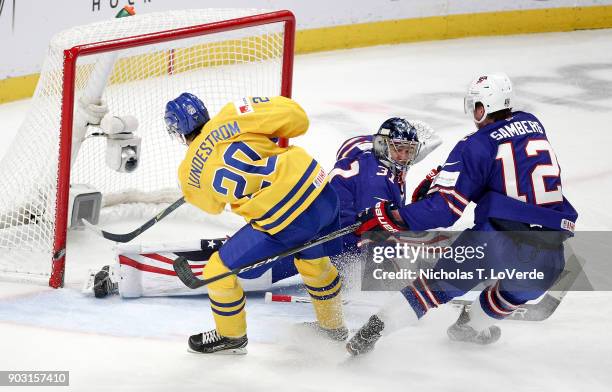 Isac Lundeström of Sweden shoots the puck just wide of the net after skating past Dylan Samberg and Joseph Woll of United States during the second...