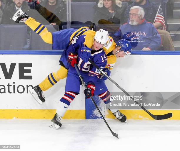 Scott Perunovich of United States checks Elias Pettersson of Sweden during the third period of play in the IIHF World Junior Championships Semifinal...