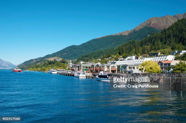 cruise boats in queenstown bay. - otago stock pictures, royalty-free photos & images