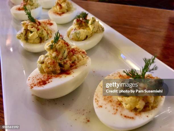 gourmet deviled eggs on a white platter - deviled egg stock pictures, royalty-free photos & images