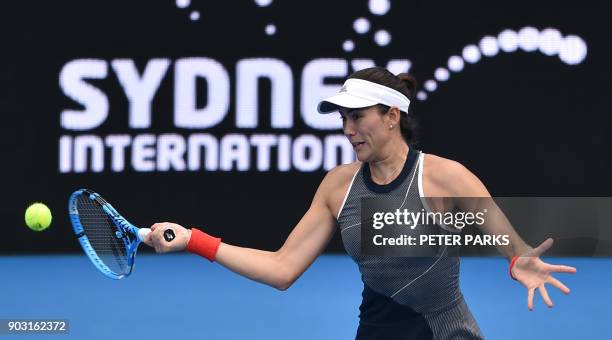 Garbiñe Muguruza of Spain hits a return to Kiki Bertens of the Netherlands in their women's singles second round match at the Sydney International...