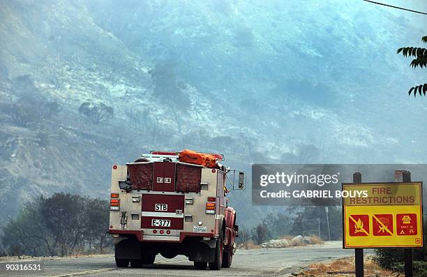 Firefighters's car goes to Tujunga, near Los Angeles, California on September 2, 2009. Firefighters were preparing to ramp up their assault on a...