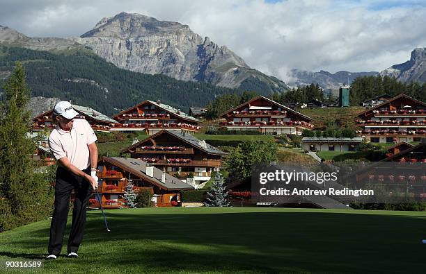 Miguel Angel Jimenez of Spain plays a chip shot on the 14th hole during the first round of The Omega European Masters at Crans-Sur-Sierre Golf Club...