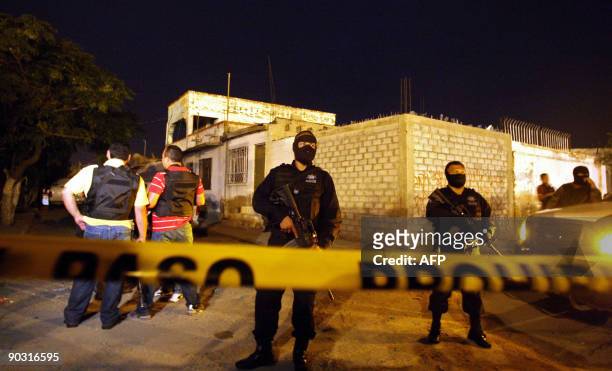 Mexican police guard the area surrounding the scene of murder, outside a drug treatment center in Ciudad Juarez, on September 3, 2009. A surge in...