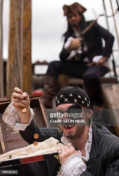 Protestors dressed as pirates pose for a Christian Aid photocall ahead of the G20 Finance Ministers meeting at The Golden Hinde galleon in central...