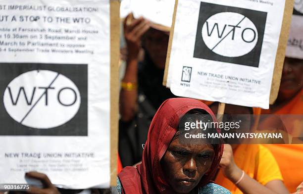 Indian Left Party activists hold placards during a protest against the World Trade Organisation in New Delhi on September 3, 2009. Trade ministers...