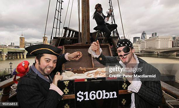 People dressed as pirates protest for the Christian Aid charity against tax avoidance on the Golden Hind ship on September 3, 2009 in London,...