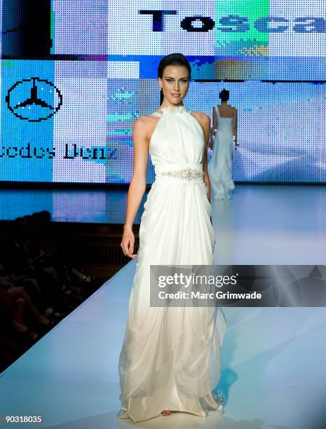 Model showcases designs by Toscano Bridal and Evening on the catwalk at the Mercedes-Benz Group Show 5 as part of Mercedes-Benz Fashion Festival...