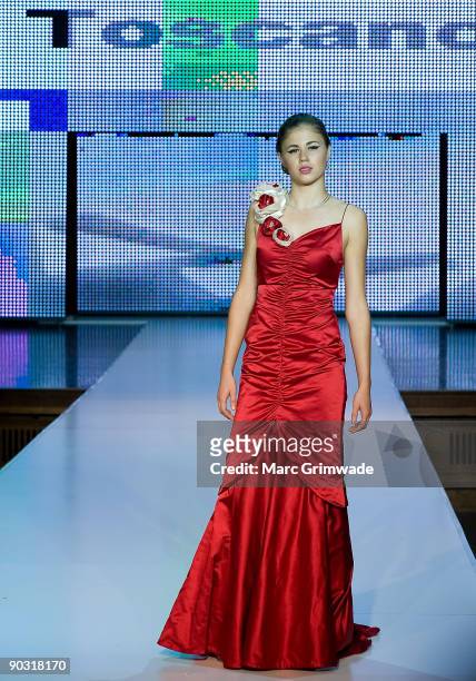 Model showcases designs by Toscano Bridal and Evening on the catwalk at the Mercedes-Benz Group Show 5 as part of Mercedes-Benz Fashion Festival...