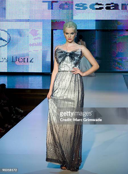 Model showcases designs by Toscano Bridal and Evening on the catwalk at the Mercedes-Benz Group Show 5 as part of Mercedes-Benz Fashion Festival...