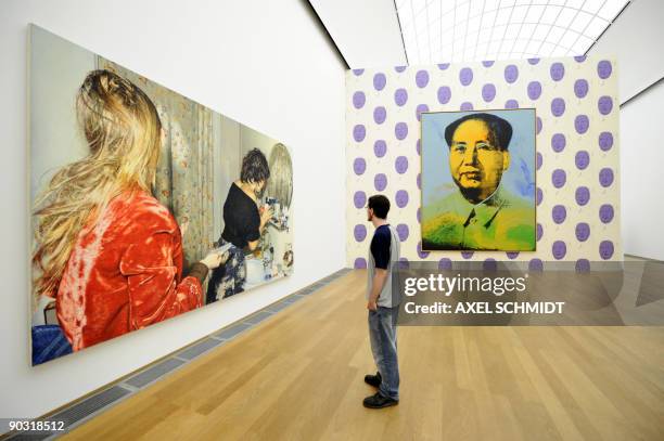 Visitor stands in front of the painting "Barbara and Gaby" by Swiss artist Franz Gertsch and "Mao" by US artist Andy Warhol at the National Gallery...