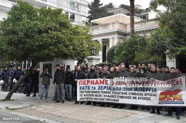 Communist-affiliated PAME workers unionists holds a banner reading "We go into a counterattack - hands off strike", on January 10 outside the Greek...