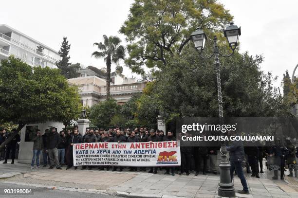 Communist-affiliated PAME workers unionists holds a banner reading "We go into a counterattack - hands off strike", on January 10 outside the Greek...