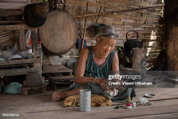 old woman using a smartphone. - indonesian farmer fotografías e imágenes de stock