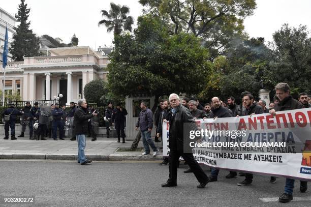Communist-affiliated PAME workers unionists hold a banner reading "We go into a counterattack - hands off strike", on January 10 outside the Greek...