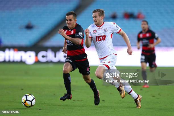 Ryan Kitto of Adelaide is challenged by Steven Lustica of the Wanderers during the round 15 A-League match between the Western Sydney Wanderers and...