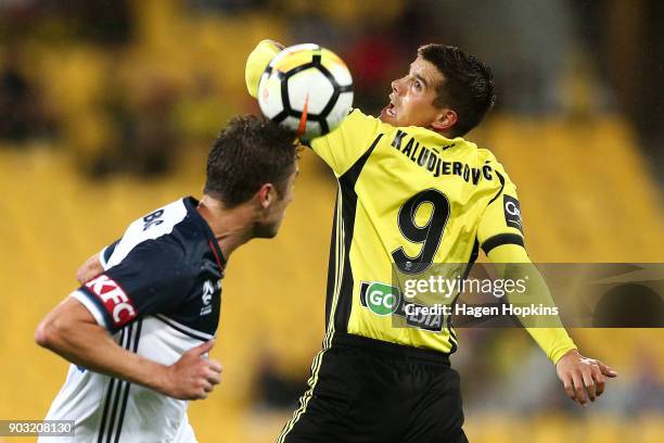 Andrija Kaludjerovic of the Phoenix and Dino Djulbic of the Victory compete for a header during the round 15 A-League match between the Wellington...