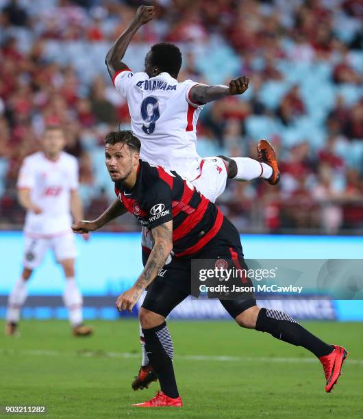 Chris Herd of the Wanderers and Baba Diawara of Adelaide compete for the ball during the round 15 A-League match between the Western Sydney Wanderers...