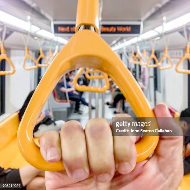 singapore, grab handle on smrt train - grab handle stock pictures, royalty-free photos & images