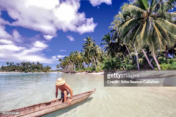 man in a canoe in the mentawai islands - indonesia mentawai canoe stock pictures, royalty-free photos & images