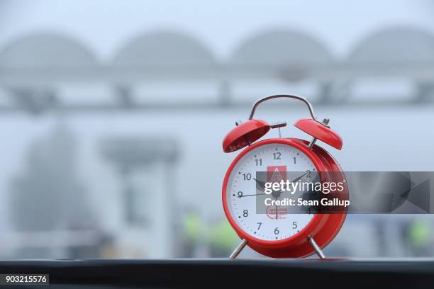 An alarm clock meant to symbolize the demand for workers to better determine their working hours stands near where workers from nearby Daimler and...