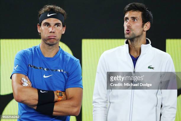 Rafael Nadal of Spain and Novak Djokovic of Serbia hits a forehand react after watching a video replay while on the sidelines during the Tie Break...