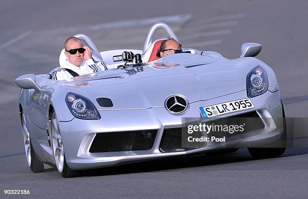 National goalkeeper Robert Ebke drives with racing driver Klaus Ludwig during a safety training at the ADAC center on September 3, 2009 in...