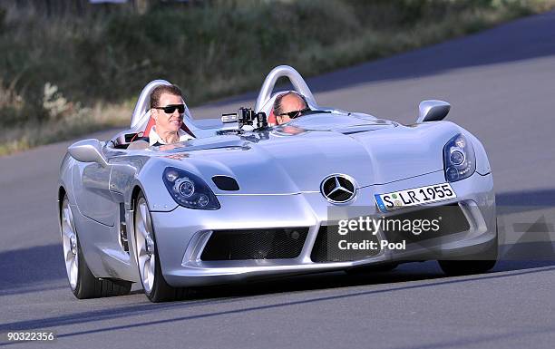 National team manager Oliver Bierhoffi drives with racing driver Klaus Ludwig during a safety training at the ADAC center on September 3, 2009 in...