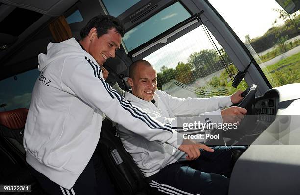 National player Piotr Trochowski and goalkeeper Robert Enke pose in the team bus during a safety training at the ADAC center on September 3, 2009 in...