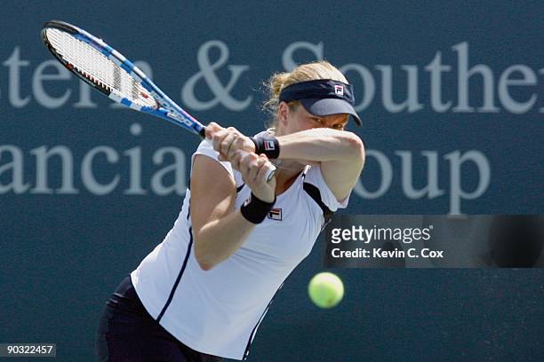 Kim Clijsters of Belgium returns a shot to Svetlana Kuznetsova of Russia during Day 4 of the Western & Southern Financial Group Women's Open on...