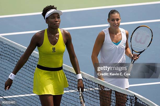 Venus Williams congratulates Flavia Pennetta of Italy after their match on Day 4 of the Western & Southern Financial Group Women's Open on August 13,...