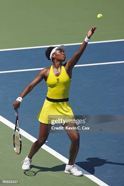 Venus Williams serves to Flavia Pennetta of Italy during Day 4 of the Western & Southern Financial Group Women's Open on August 13, 2009 at the...